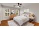 Relaxing bedroom features a ceiling fan, shutters, modern dresser and comfortable bed at 912 Chipley Ct, Marietta, GA 30062