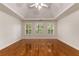 Inviting bedroom offers hardwood floors, tray ceilings, and ample natural light from three windows at 912 Chipley Ct, Marietta, GA 30062