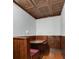 Basement dining booth with wood walls, seating, table and an intricately designed copper-tone ceiling at 912 Chipley Ct, Marietta, GA 30062