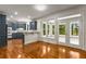 Dining area leading to a kitchen with new appliances, stone countertops and stainless fixtures at 912 Chipley Ct, Marietta, GA 30062