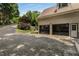 Elegant paved driveway leading to a three-car garage, complemented by mature trees and landscaping for enhanced curb appeal at 912 Chipley Ct, Marietta, GA 30062