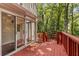 Exterior of home featuring a sunroom with a connected red deck and a view of the surrounding forest at 912 Chipley Ct, Marietta, GA 30062
