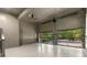 Spacious three-car garage with epoxy flooring, ceiling fan, and glass doors allowing natural light and a view of the outdoors at 912 Chipley Ct, Marietta, GA 30062