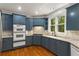 Kitchen featuring stone countertops, stainless appliances and light fixtures at 912 Chipley Ct, Marietta, GA 30062