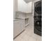 Modern laundry area features white cabinets, a sink, and a stackable washer and dryer unit at 912 Chipley Ct, Marietta, GA 30062