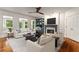 Bright living room featuring a fireplace, built-in bookshelves, large windows and hardwood floors at 912 Chipley Ct, Marietta, GA 30062