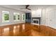 Bright living room featuring a fireplace, built-in bookshelves, large windows and hardwood floors at 912 Chipley Ct, Marietta, GA 30062