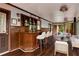Bright living room with hardwood flooring, a bar area with stools, and a relaxing atmosphere with a view of the forest at 912 Chipley Ct, Marietta, GA 30062