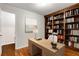 Office with hardwood floors, built-in bookshelf, desk, and natural light at 912 Chipley Ct, Marietta, GA 30062