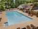 Community pool surrounded by lounge chairs and umbrellas, offering a refreshing oasis for relaxation and recreation at 912 Chipley Ct, Marietta, GA 30062