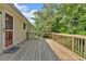 Back deck with wooden railing that leads to a large lush green backyard at 19 Quail Hollow Ct, Dallas, GA 30157