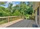 Wooden back deck with lush green backyard view, perfect for relaxing and outdoor entertaining at 19 Quail Hollow Ct, Dallas, GA 30157