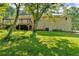 Back exterior view of home with large, lush backyard at 19 Quail Hollow Ct, Dallas, GA 30157