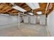 Unfinished basement space with white walls, concrete floor, and exposed wooden ceiling at 19 Quail Hollow Ct, Dallas, GA 30157