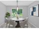 Cozy dining area with round table, comfortable seating, and a view to the outside at 19 Quail Hollow Ct, Dallas, GA 30157