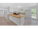 Updated kitchen with white cabinets, tile flooring, and butcher block countertops at 19 Quail Hollow Ct, Dallas, GA 30157