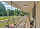 Covered front porch boasts a swing and wood flooring, perfect for relaxing outdoors at 19 Quail Hollow Ct, Dallas, GA 30157
