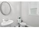 Half bath features a modern pedestal sink and toilet at 2013 Chesley Dr, Austell, GA 30106