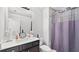 Bathroom with vanity, lighting, toilet and bathtub with shower featuring a purple curtain at 2013 Chesley Dr, Austell, GA 30106