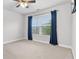 Bedroom featuring a ceiling fan, window with natural light and soft carpet at 2013 Chesley Dr, Austell, GA 30106