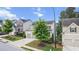 Street view of the home featuring a two-car garage, manicured lawn, and lush landscaping at 2013 Chesley Dr, Austell, GA 30106