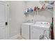 Functional laundry room with modern washer and dryer, and overhead shelving for storage at 2013 Chesley Dr, Austell, GA 30106