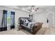 Spacious primary bedroom with a tray ceiling, windows, and a stylish, upholstered bed at 2013 Chesley Dr, Austell, GA 30106