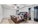 Bright main bedroom featuring a large bed, ceiling fan, and natural light at 2013 Chesley Dr, Austell, GA 30106