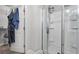A tiled shower with glass doors, and an adjacent closet for storage at 2013 Chesley Dr, Austell, GA 30106