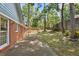 A backyard features a brick exterior home with large trees and a wood fence at 2611 Leeshire Ct, Tucker, GA 30084