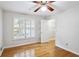 Bedroom with hardwood floors, ceiling fan, plantation shutters, and walk-in closet at 2611 Leeshire Ct, Tucker, GA 30084