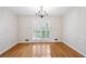 Bright dining room boasts hardwood floors, elegant chandelier, and french doors to the exterior at 2611 Leeshire Ct, Tucker, GA 30084