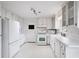 Well-lit white kitchen featuring modern appliances, ample cabinet space, and a functional layout at 2611 Leeshire Ct, Tucker, GA 30084