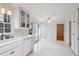 Spacious kitchen with white cabinets, countertops, and appliances, plus large windows for natural light at 2611 Leeshire Ct, Tucker, GA 30084