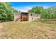 Expansive backyard featuring a charming deck, complemented by a wooden fence and lush surrounding trees at 428 Hulseytown Rd, Dallas, GA 30157
