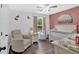 A cozy Bedroom features a comfortable chair, crib, and pink accent wall at 428 Hulseytown Rd, Dallas, GA 30157