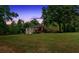 Charming house with a beautiful yard surrounded by mature trees, captured during a colorful sunset at 428 Hulseytown Rd, Dallas, GA 30157