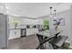 White kitchen features stainless appliances, breakfast bar with granite countertop, and subway tile backsplash at 428 Hulseytown Rd, Dallas, GA 30157