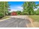 Property features an outbuilding with double doors, next to the car port and long driveway at 428 Hulseytown Rd, Dallas, GA 30157