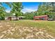 Expansive yard featuring an outbuilding, long driveway, and car port, ideal for outdoor activities at 428 Hulseytown Rd, Dallas, GA 30157