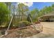 Relaxing backyard with a charming swing set and lush foliage at 4286 Pool Rd, Winston, GA 30187