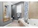 Bright bathroom featuring a soaking tub with tiled surround and a stylish vanity at 4286 Pool Rd, Winston, GA 30187