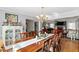 Elegant dining room with hardwood floors, classic chandelier, and seamless flow into the living space at 4286 Pool Rd, Winston, GA 30187