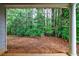 Inviting back porch view showcasing tranquil wooded scenery, seamlessly connecting indoor and outdoor living spaces at 10247 Deep Creek Pl, Union City, GA 30291