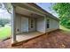 Backyard with concrete patio, convenient access door, windows, and a grassy lawn with mature trees at 10247 Deep Creek Pl, Union City, GA 30291