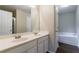 Bathroom featuring double sink vanity, large mirror, and door to separate toilet and shower area at 10247 Deep Creek Pl, Union City, GA 30291