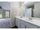 Bathroom featuring a double sink vanity, large mirror, and door to the main bedroom at 10247 Deep Creek Pl, Union City, GA 30291