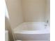 Bathroom featuring white tiled tub and toilet at 10247 Deep Creek Pl, Union City, GA 30291
