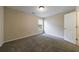 Cozy bedroom featuring gray carpet, neutral walls, and a window providing natural light at 10247 Deep Creek Pl, Union City, GA 30291