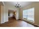Dining area with an elegant chandelier, hardwood flooring, and a large window at 10247 Deep Creek Pl, Union City, GA 30291